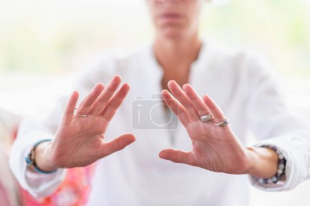 Photo for Mindful woman performing respect gesture with her hands. Spiritual awakening. - Royalty Free Image
