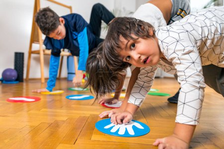 Photo for Group of Children Playing Twister Indoors - Royalty Free Image