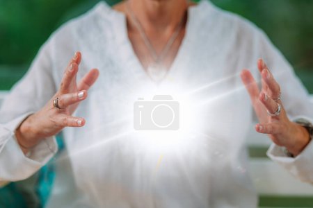 Photo for Spiritual enlightenment. Enlightened spiritual teacher emits glowing energy ball - Royalty Free Image