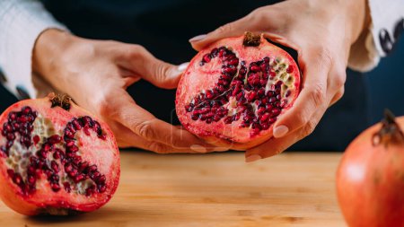 Photo for Woman hands holding pomegranate - Royalty Free Image