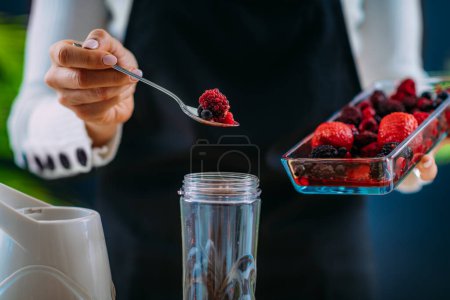 Photo for Woman Making Healthy Shake with Berries - Royalty Free Image