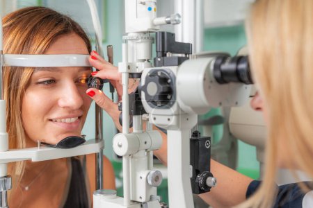 Photo for Detailed ophthalmological examination using a magnifying glass, ensuring precise eye health assessment in a clinical setting - Royalty Free Image