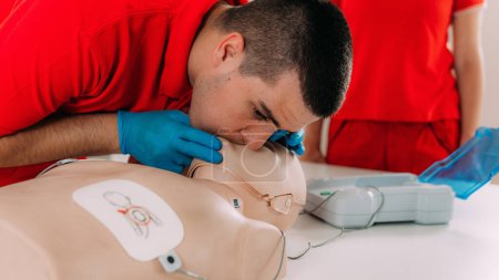 Photo for AED first aid resuscitation course. Life saving skills in a first aid resuscitation course using an AED - Royalty Free Image