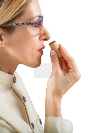 Photo for Wine tasting, woman sniffing a wine cork, isolated - Royalty Free Image