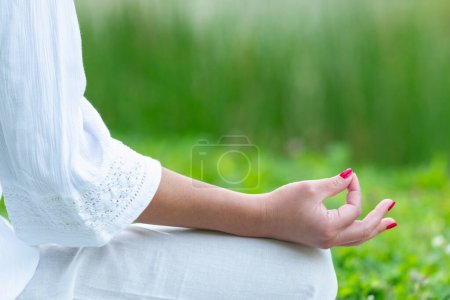 Photo for Mindfulness in detailed meditation moment. Focus in this close-up of a woman's hand during meditation, capturing the essence of calmness and introspection - Royalty Free Image