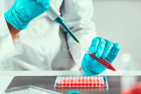 Photo for Laboratory technician using micro pipette - Royalty Free Image