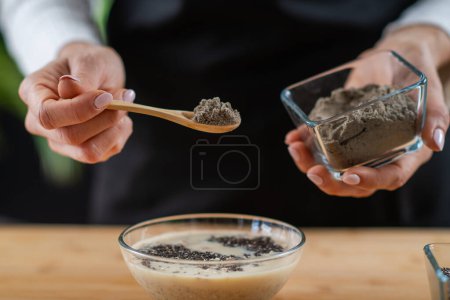 Photo for Woman preparing Oatmeal featuring oats, soy milk, and plant protein powder, showcasing the fusion of health and flavor - Royalty Free Image