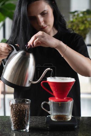 Photo for Female barista meticulously prepares drip coffee - Royalty Free Image