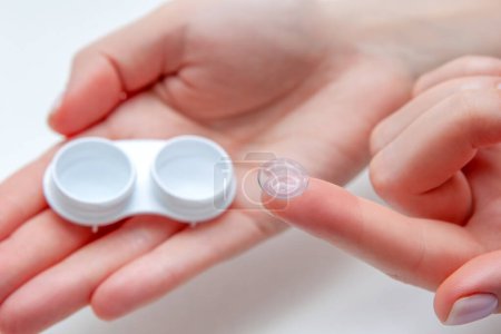 Photo for Contact Eye Lenses. Woman Hands Holding Contact Eye Lens. Woman Hands Holding White Container. Beautiful Woman Fingers Holding Eye Lens Box. Health And Eyes Care Concept. High Resolution - Royalty Free Image