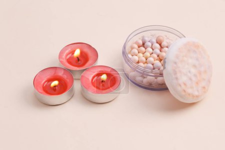 Foto de Spa salon, beauty concept. Powder balls with aroma candles on a beige background - Imagen libre de derechos