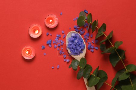 Téléchargez les photos : Spas, aromatherapy. Lavender bath salt with aroma candles and sprig of eucalyptus on red background - en image libre de droit