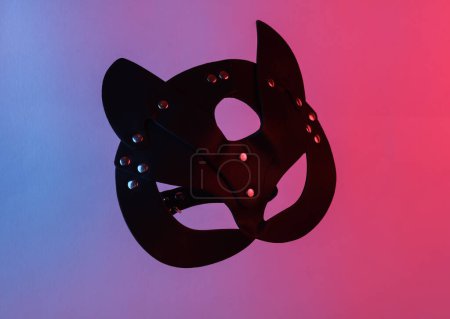 Photo for Sex shop leather cat mask floating in the air, isolated in blue-red neon gradient light. Levitating objects. Minimal concept. Sex games - Royalty Free Image