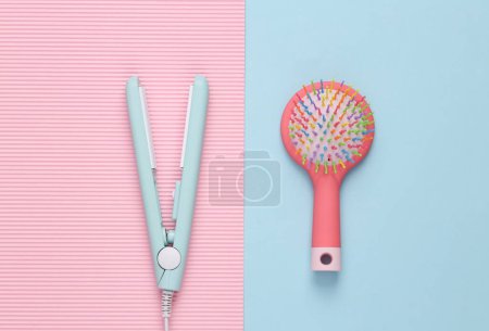 Photo for Mini hair straightener with hair brush on a blue background. Hair style. Top view - Royalty Free Image