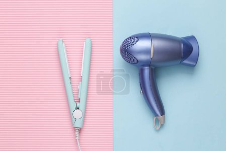 Photo for Hair straightener with hair dryer on a blue background. Hair style. Top view - Royalty Free Image