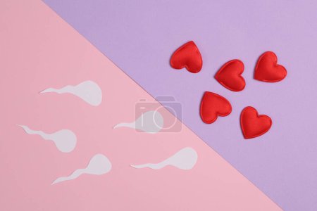 Spermatozoa with hearts on a pastel background. Love, conception, sex concept