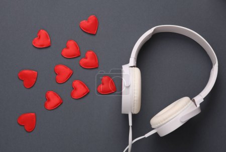 Foto de Auriculares estéreo con corazones sobre un fondo gris. Música romántica - Imagen libre de derechos