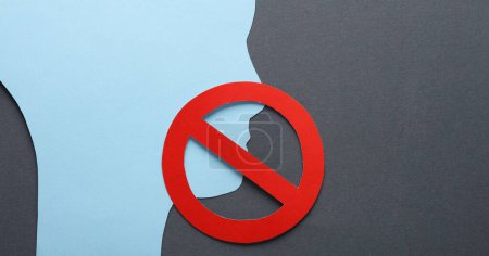 Photo for Paper cut face silhouette with prohibition sign on gray background. Prohibition of freedom of speech, censorship - Royalty Free Image