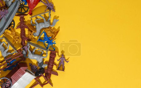 Set of soldiers and figurines from the theme of the wild west. Cowboys and American Indians. Creative layout, yellow background. Copy space