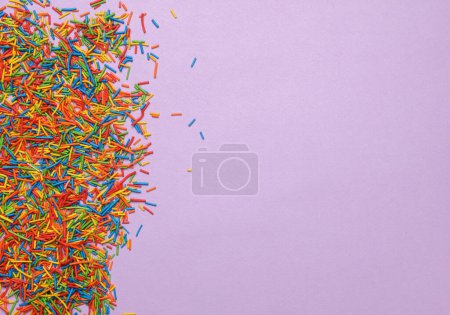 Photo for Sprinkles for cake on purple pastel background. Copy space - Royalty Free Image