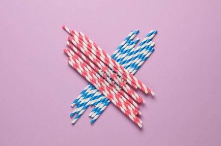 Photo for Colored paper straws on a pink background. Party, birthday accessories - Royalty Free Image