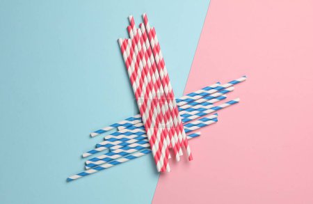 Photo for Blue and red paper straws on pastel background. Party, birthday accessories - Royalty Free Image