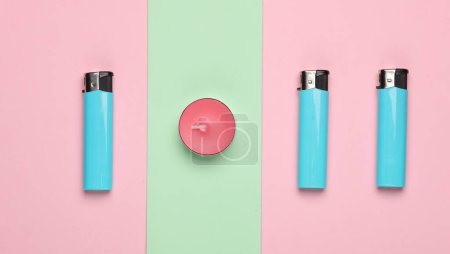 Aroma tea candle with lighters on a pink blue pastel background. Top view