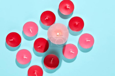 Téléchargez les photos : Bougies Arôme rouge et rose sur fond bleu. Mise en page créative, minimalisme - en image libre de droit