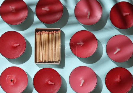 Téléchargez les photos : Bougies de thé arôme et Matchbox sur fond bleu. Mise en page créative - en image libre de droit