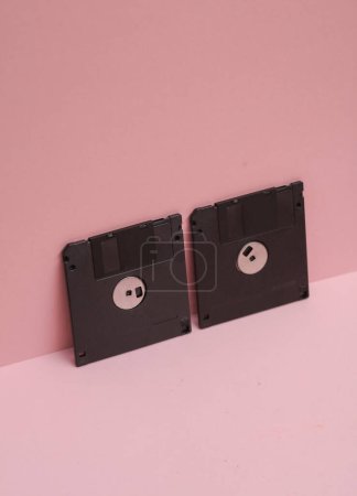 Outdated technologies. Retro 80s floppy disks on  pink background. Creative layout
