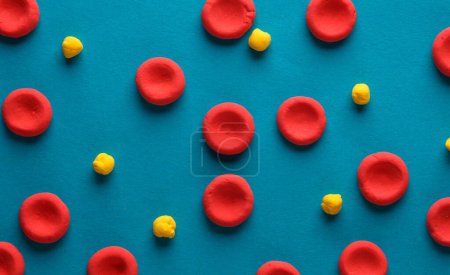 Photo for Red blood cells with lipids model made from plasticine on blue background. Cholesterol - Royalty Free Image
