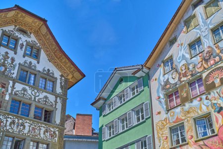 Photo for Lucerne, Switzerland - July 13, 2022: Historic painted medieval houses in the old town - Royalty Free Image
