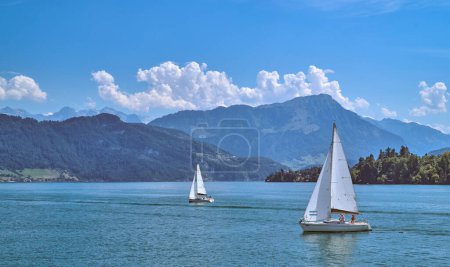 Photo for Lucerne, Switzerland - July 14, 2022: Panoramic view of the Lucern lake with sailing boats and  the Alpine mountains in the background - Royalty Free Image