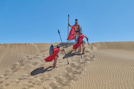 Photo for Maspalomas, Gran Canaria, Spain - March 18, 2023: Actors in Roman costume during a film set on the  Sand Dunes National Park, - Royalty Free Image