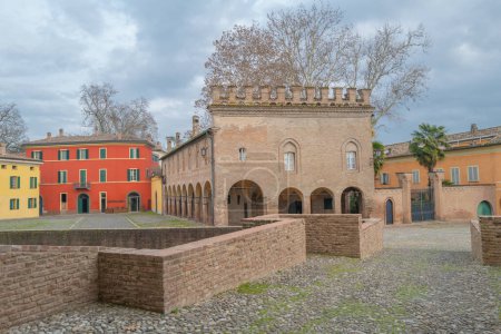 Photo for Fontanellato, Itally, the Sanvitale  former ancient stables and the colorful houses of the village seen from the fortress entrance - Royalty Free Image