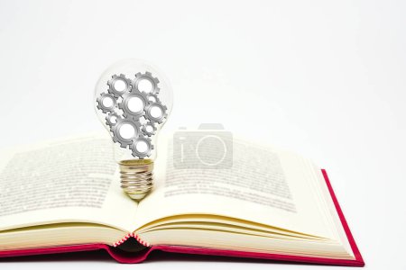 Foto de Light bulb with gear or cogwheel is placed on book. Concept of knowledge, wisdom, new ideas and creativity. - Imagen libre de derechos