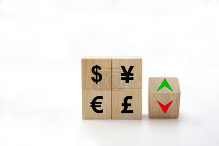 Photo for The exchange rate icon on wooden block cubes and arrows show lowering and increasing according to the index exchange rate. - Royalty Free Image