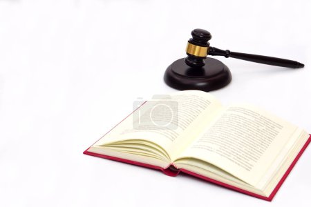 Selective focus, law book and judge gavel or hammer placed behind. Law, judiciary concept.