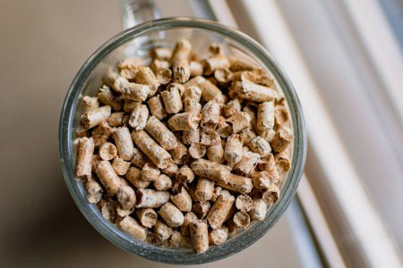 Pellet for stove or boiler in a glass, compressed wood granule