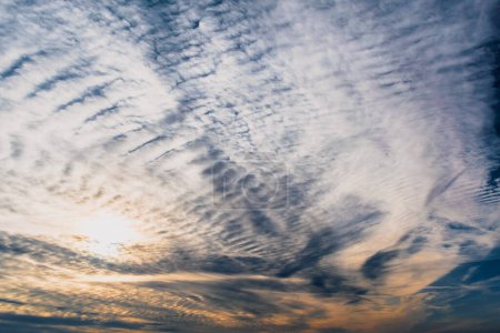 Beautiful striated cloud formation in sky looking like fluffy waves, weather forecast