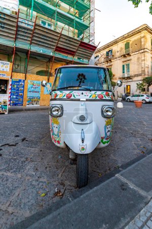 Photo for Syracuse, Sicily, Italy - November 21, 2022: A traditional three wheel taxi on the streets of Siracusa, Italy. - Royalty Free Image