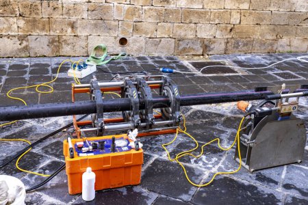 Photo for Butt fusion welding machine pipe welding machine for connecting water pipes together during a new building water supplies project. - Royalty Free Image