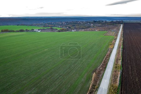 Amazing wide aerial view from drone of beautiful green countryside, fields and road