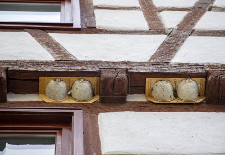 Photo for Nests with small swallows under a wooden beam of the house. - Royalty Free Image
