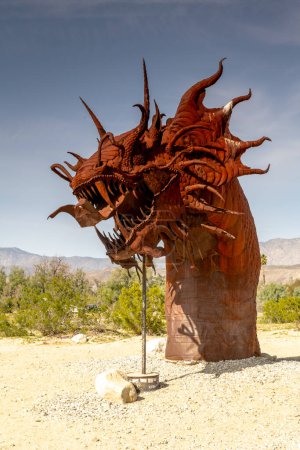 Golden Sands, Azure Sky, and a Dragon Sculpture in Anza-Borrego Desert State Park. The majestic dinosaur sculpture rises from the desert sands, blending seamlessly with the expansive blue sky, 