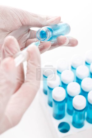 Photo for Doctor with vials of vaccine and syringe - Royalty Free Image