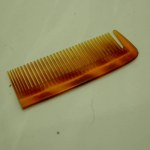 comb, straight razor isolated on white background, closeup.