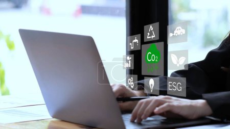 Photo for Person using laptop for working technology and business Net zero and carbon neutral concept. Renewable energy-based green businesses can limit climate change and global warming. Reduce CO2 emission - Royalty Free Image