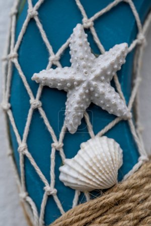 Photo for Sea star on white Fishing nets and blue rescue cupboard - Royalty Free Image