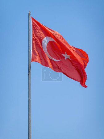 Photo for The Turkey flag against clear blue sky moving with the wind . - Royalty Free Image