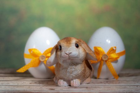 Photo for Eggs wrapped in a colorful gift tie with a rabbit. Easter, Pascha or Resurrection Sunday concept - Royalty Free Image